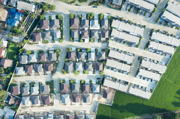 Housing estate in aerial view. That village or community consist of residential building in land lot. Real estate or property from development by construction for owned, sale, mortgage and investment.
