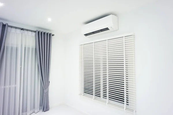 Venetian blind and air conditioner (ac) wall mount or indoor unit of split system consist of electric fan, filter and evaporator coil for climate, temperature and humidity control in room of home.