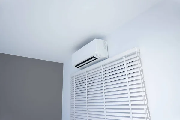 Air conditioner (ac) wall mount or indoor unit of split system for control climate, temperature and humidity. Include adjusting vertical or venetian blinds for adjust natural light to inside room.