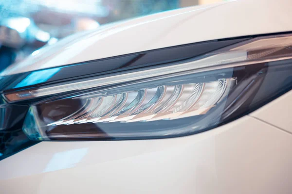 Closeup detail of headlight of auto car consist of led bulb, signal indicator turn light, lamp part, daytime running light. Concept for automotive vehicle, automobile, luxury, polish, clean and wash.