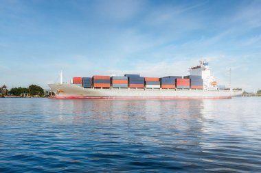 Big cargo ship at side view. To carry cargo container and cruise, travel or float in sea, canal. Freight transport industry for shipping, shipment, logistics. Global business for trade, import export.