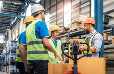 Manager, staff or boss to talking, discussion with worker, employee. Group of people in warehouse, factory with safety helmet, vest. Concept for industry, job, meeting, work training and teamwork.