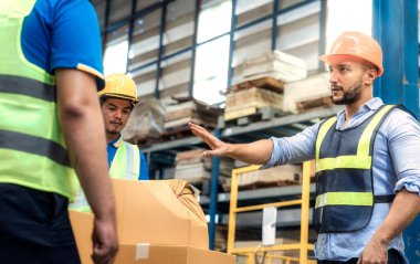 Supervisor, manager or boss to angry, scold or mad to worker, employee inside distribution warehouse about bad, damage, broken or dented of cardboard box package. May called carton, parcel, cargo.