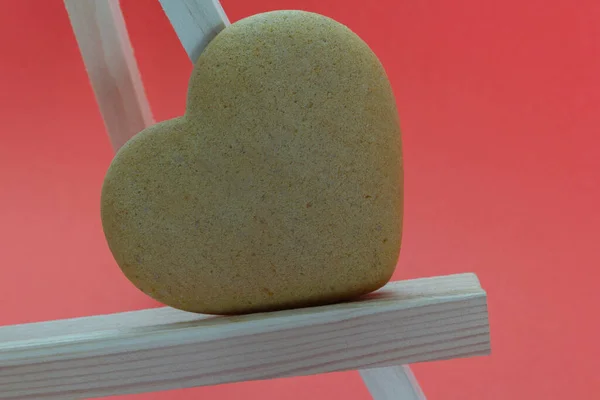 Heart shaped homemade gingerbread on a light wooden stand red background, Valentines Day, greeting card, pastry, Copy space, top view, love concept, Engagement, love — Photo
