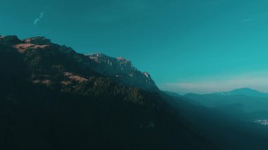 Dağlarda güzel bir gün batımı. Güneş ışınları bulutlar arasında parlıyor.