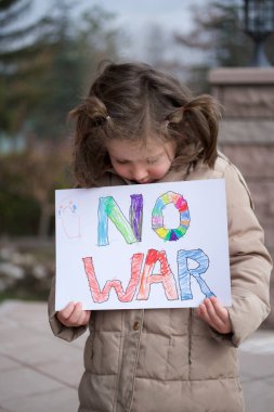 Küçük kız savaşı savaş bayrağıyla protesto ediyor. Seçici odaklanma. Barış ve özgürlük.