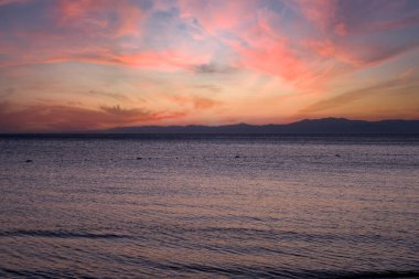 İnanılmaz deniz ve kızıl gökyüzü gün batımında