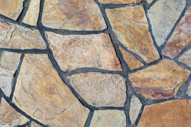 Vahşi bir taşın taklidi. Sert desenli yüzey. Tasarım için boş veya grafik kaynak arkaplanı.