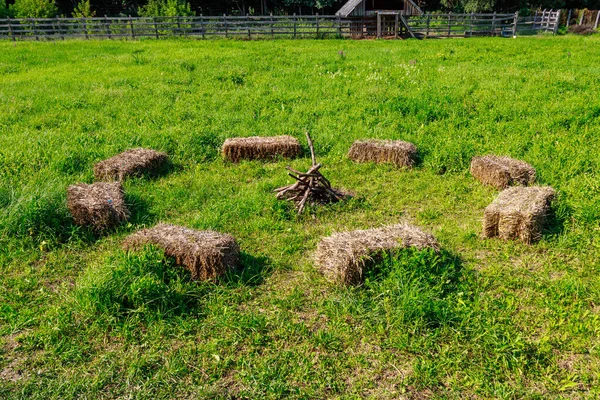 Pressed parallelepipeds or hay cubes used for seat instead of benches. Village rest after work. Background with copy space for text or inscriptions.