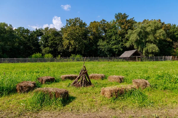 Pressed parallelepipeds or hay cubes used for seat instead of benches. Village rest after work. Background with copy space for text or inscriptions.