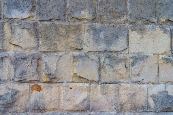 野生の装飾石のブロックで作られたラフな質感の壁の表面 テキストや碑文のためのコピースペースを持つ背景 デザインのテンプレートまたはデザイナーのグラフィックリソース 一番下 — ストック写真