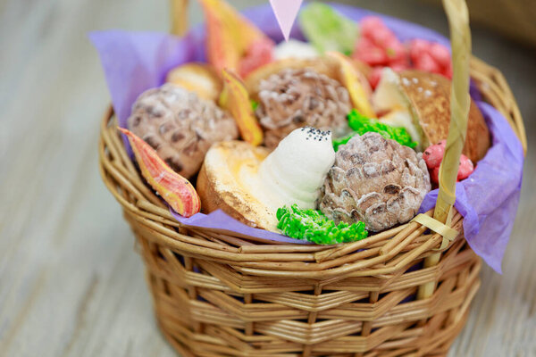 Basket of marshmallow edible gift decorations. Selective focus. Background with copy space for text