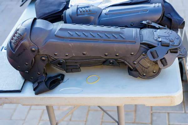 Police leg guards or knee pads, selective focus. Ammunition for the police or a special squad. Equipment for a special operation. Crime news. Background with copy space.