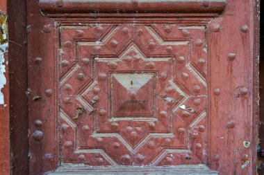 Rough textured painted wood carved surface of an old retro vintage door. Background or graphic resource for design