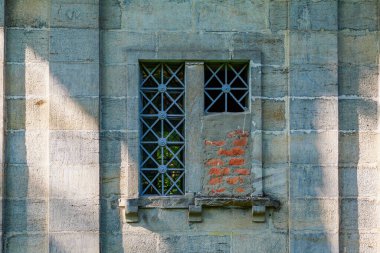 Window with bars and walled up part. Background with copy space for text