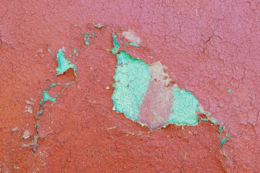 Rough textured surface of a wall made of clay or adobe, background. Cracked old paint. Backdrop or graphic resource for design. Eco tourism and village recreation concept