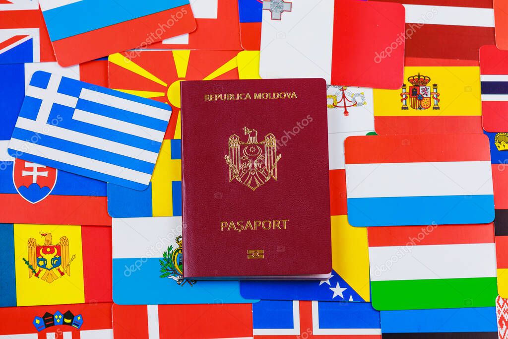 Modern foreign passport of a citizen of the Republic of Moldova. Against the background of the flags of different European countries.