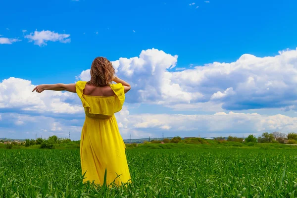 Young Woman Yellow Dress Outdoors Green Field Hands Raised Sky — Stock Photo, Image