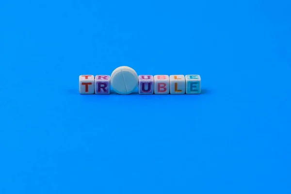 Trouble Text Würfeln Eine Weiße Medizinische Pille Mit Einer Partitur — Stockfoto