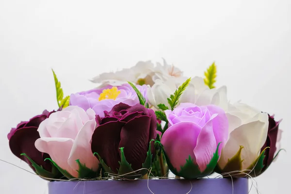 Artificial flowers made from soap. Gift bouquet with selective focus. Congratulations on the birthday of a girl or a holiday for women. Wedding and engagement.