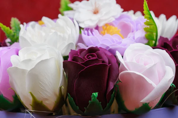 Artificial flowers made from soap. Gift bouquet with selective focus. Congratulations on the birthday of a girl or a holiday for women. Wedding and engagement. Close-up background.