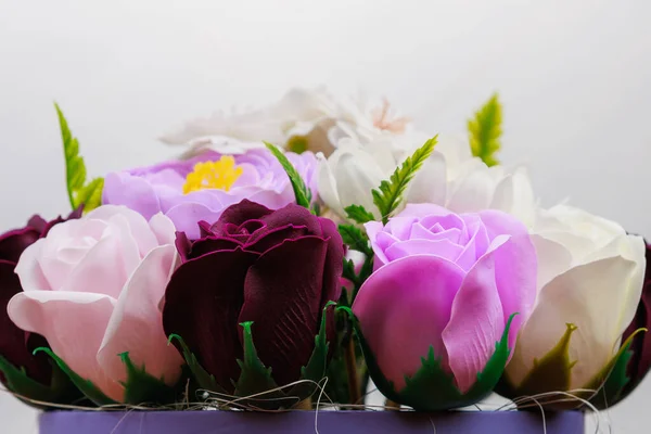 Artificial flowers made from soap. Gift bouquet with selective focus. Congratulations on the birthday of a girl or a holiday for women. Wedding and engagement.