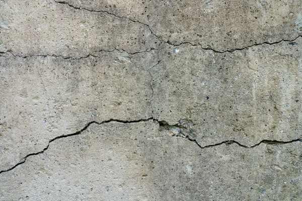 Cracked concrete slab. Wall made of cement with a crack. House foundation repair. Texture surface or background