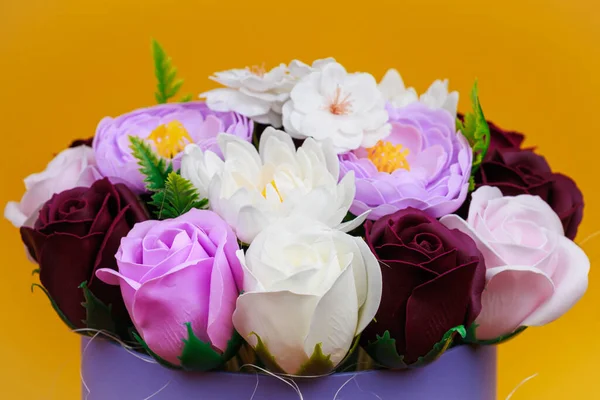Artificial flowers made from soap. Gift bouquet with selective focus. Congratulations on the birthday of a girl or a holiday for women. Wedding and engagement.