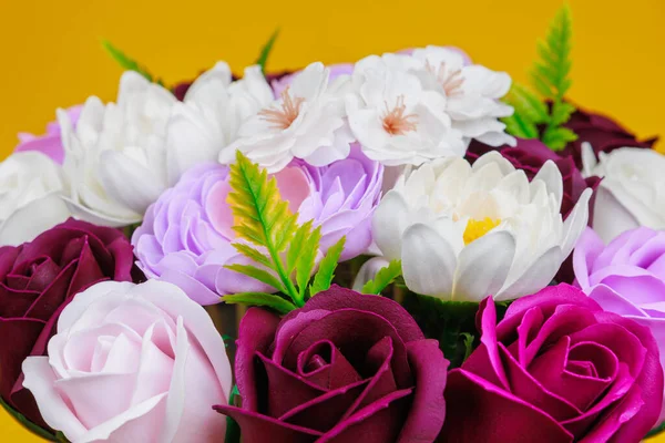 Artificial flowers made from soap. Gift bouquet with selective focus. Congratulations on the birthday of a girl or a holiday for women. Wedding and engagement.