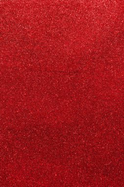 Işıltılı bir arka plan. Arkaplanda simler var. Parlak desenli yüzey. Dikey görüntü. Güçlü kırmızı. Yumuşak ışık