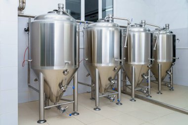 Bira fabrikasında veya yiyecek içecek endüstrisinde paslanmaz çelik üretim varilleri. Kopyalama alanı olan arkaplan