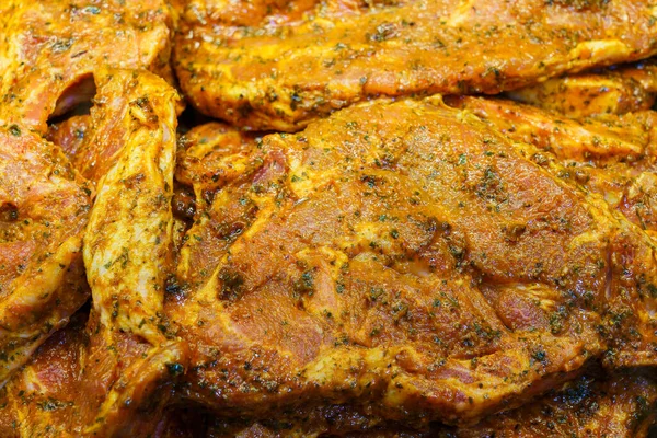 Marinated steak in a grocery store fridge, selective focus. Background with copy space for text