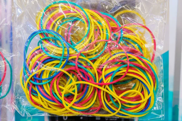 Stationery rubber bands in a package close-up, selective focus. Background with copy space for text