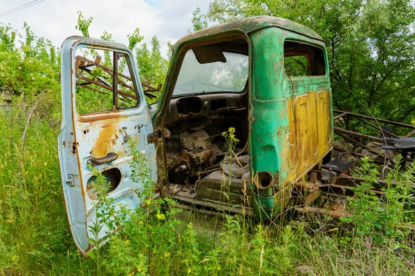 The body of an old car in an abandoned car cemetery. Background with copy space for text