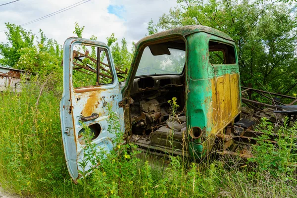 The body of an old car in an abandoned car cemetery. Background with copy space for text