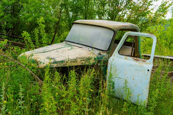 The body of an old car in an abandoned car cemetery. Background with copy space for text