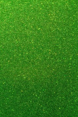 Işıltılı bir arka plan. Arkaplanda simler var. Parlak desenli yüzey. Dikey görüntü. Koyu yeşil. Yumuşak ışık