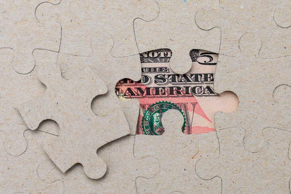 Missing puzzle piece and framed US dollars. Background with copy space for text