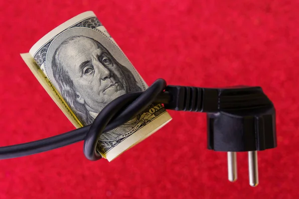 Knotted electric cord around the neck of the president of the dollar bill, selective focus. The concept of the energy crisis and electricity inflation. Rising electricity prices. Copy space.