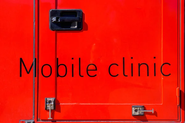The inscription on the door of the Mobile Clinic truck. Background with selective focus and copy space for text