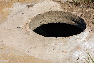 Open sewer without manhole. Background with selective focus and copy space for text