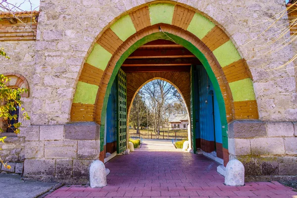 Stone arch at the entrance to the old stone church. Background with selective focus and copy space for text. Classic vintage architecture