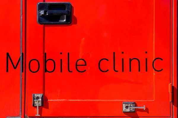 The inscription on the door of the Mobile Clinic truck. Background with selective focus and copy space for text