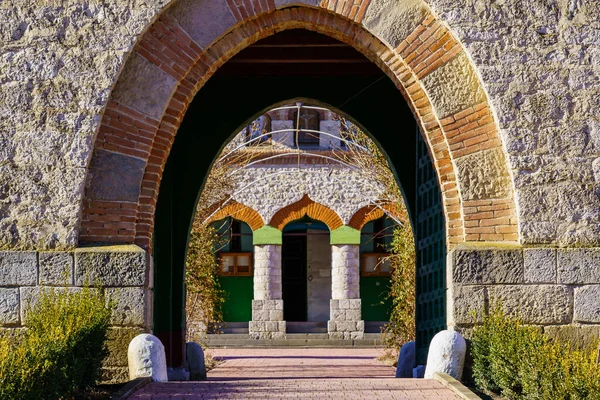 Stone arch at the entrance to the old stone church. Background with selective focus and copy space for text. Classic vintage architecture