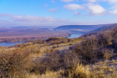 Beautiful view of the hilly valley with the river soothing winter nature. Background with copy space for text