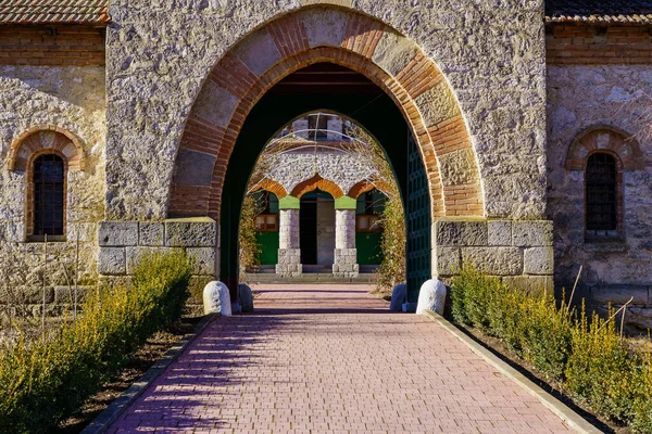 Stone arch at the entrance to the old stone church. Background with selective focus and copy space for text. Classic vintage architecture