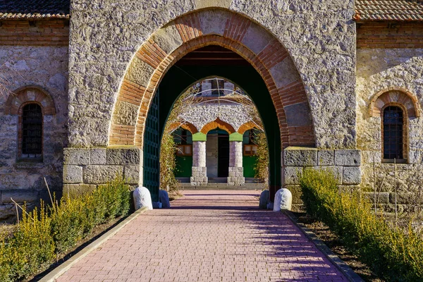 Stone arch at the entrance to the old stone church. Background with selective focus and copy space for text. Classic vintage architecture