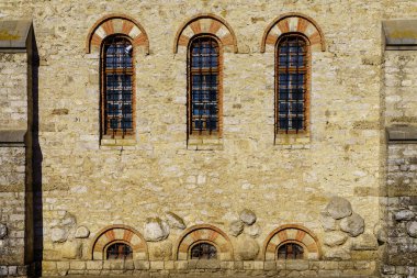 Windows of an ancient stone building of classical architecture. Background with selective focus and copy space for text