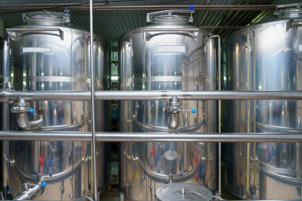 A stainless steel vat in the food industry at a brewery in the process of brewing beer. Background with selective focus and copy space for text