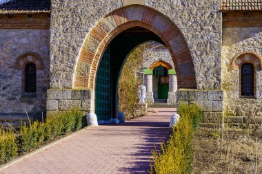 Stone arch at the entrance to the old stone church. Background with selective focus and copy space for text. Classic vintage architecture